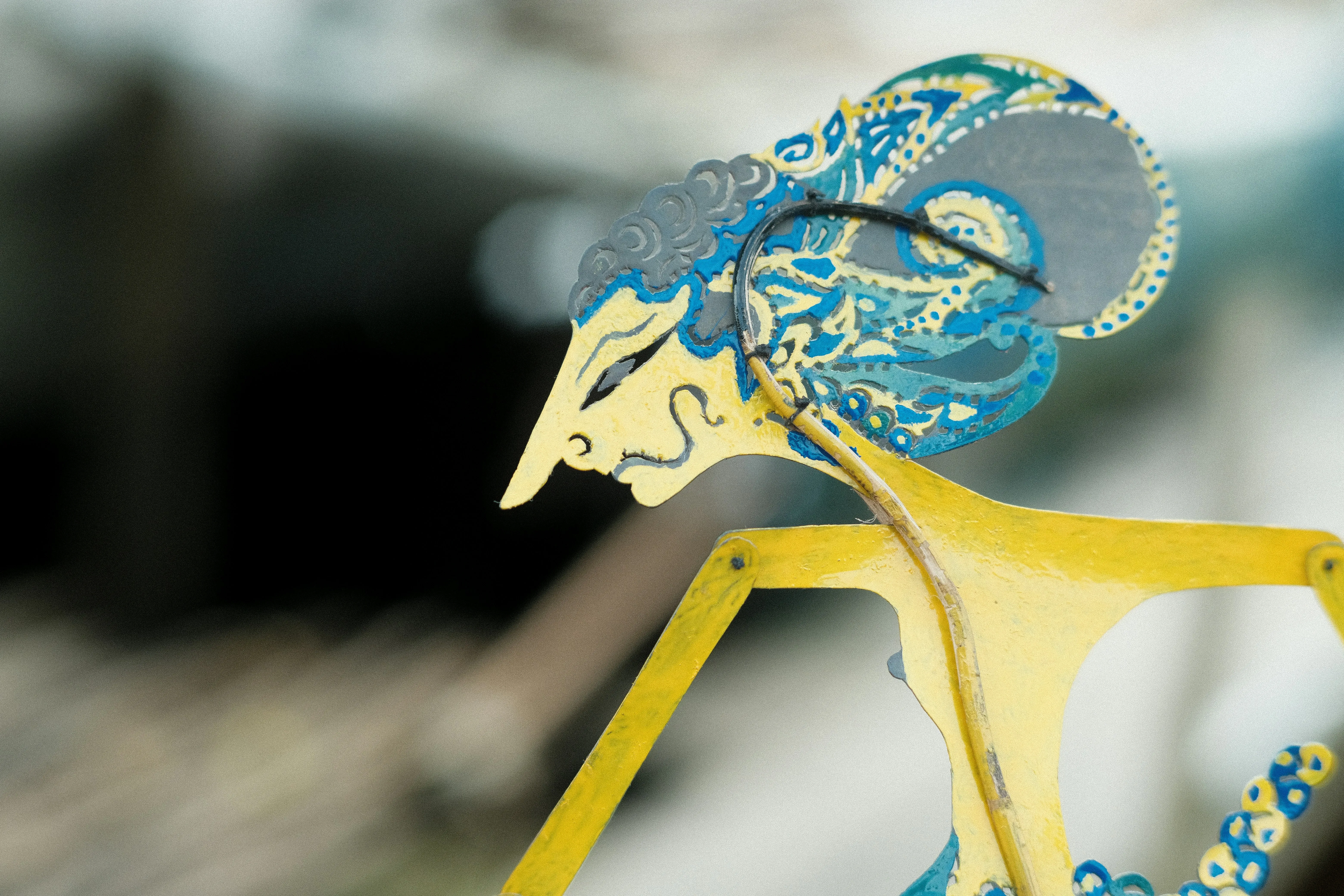 Wayang kulit performance on stage, leather puppets lit from behind a white screen